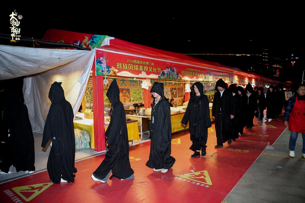 A group of people is walking around a city in a black clothing.