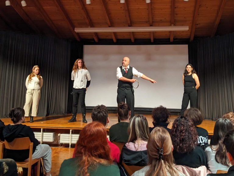 Photo of all four actors engaging in dialogue with the audience about the text