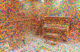 Picture of Obliteration Room, featuring a piano in a corner. The entire set is covered in colourful stickers, to the point where the piano blends in with the walls.